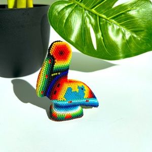 Multicolored beaded wooden carved toucan